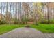 A brick patio and firepit anchors the backyard, which is surrounded by a mature tree line at 9 Water Stone Ct, Durham, NC 27705
