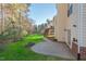 Enjoy a backyard featuring a brick patio, firepit, mature trees, and a wooden staircase to a second story porch at 9 Water Stone Ct, Durham, NC 27705