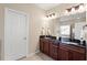 Bathroom with granite countertop and cabinets, tiled flooring and a white paneled door at 9 Water Stone Ct, Durham, NC 27705