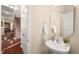 Charming powder room features a pedestal sink, neutral walls, and a decorative mirror at 9 Water Stone Ct, Durham, NC 27705