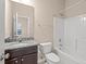 Bathroom with a vanity and a shower-tub combo featuring a granite countertop and cabinetry at 9 Water Stone Ct, Durham, NC 27705