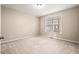 Empty bedroom with natural light and neutral carpeting at 9 Water Stone Ct, Durham, NC 27705