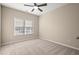 Bright bedroom featuring neutral walls, carpet and a ceiling fan and a large window providing light at 9 Water Stone Ct, Durham, NC 27705