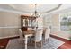 Inviting dining room with classic chandelier, neutral paint, and natural light, perfect for Gathering dinners at 9 Water Stone Ct, Durham, NC 27705