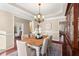 Elegant dining room with classic chandelier, neutral paint, and natural light, perfect for Gathering dinners at 9 Water Stone Ct, Durham, NC 27705