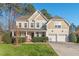 Charming two-story home with a manicured front yard and a two-car garage offers great curb appeal at 9 Water Stone Ct, Durham, NC 27705