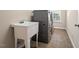 Bright laundry room features a utility sink, tile flooring and modern, front-loading washer and dryer at 9 Water Stone Ct, Durham, NC 27705