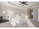 Sun-drenched main bedroom with tray ceiling, neutral palette, and plush carpeting throughout at 9 Water Stone Ct, Durham, NC 27705