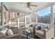 Cozy screened-in porch with comfortable seating, a ceiling fan, and views of the wooded backyard at 9 Water Stone Ct, Durham, NC 27705
