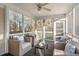 Comfortable screened-in porch with ceiling fan, furniture, and views of the wooded backyard at 9 Water Stone Ct, Durham, NC 27705