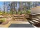 Beautiful backyard with a deck, lush landscaping, and mature trees at 901 Emory Ln, Raleigh, NC 27609