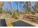 Landscaped backyard with tiered planting beds and wooden deck at 901 Emory Ln, Raleigh, NC 27609
