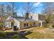 The spacious backyard features a covered porch, mature trees, and ample space for outdoor activities and relaxation at 901 Emory Ln, Raleigh, NC 27609