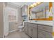 Updated bathroom with granite countertops, gray cabinets, and a decorative mirror at 901 Emory Ln, Raleigh, NC 27609
