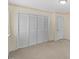 Bedroom closet with folding doors and nearby entry door at 901 Emory Ln, Raleigh, NC 27609