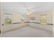 Spacious bedroom with three windows, ceiling fan, and neutral decor at 901 Emory Ln, Raleigh, NC 27609