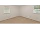 Empty carpeted bedroom with two windows and neutral paint at 901 Emory Ln, Raleigh, NC 27609