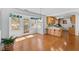 Open breakfast nook with hardwood floors, view to kitchen and backyard through surrounding windows at 901 Emory Ln, Raleigh, NC 27609