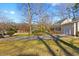 This home boasts a spacious front yard, a long driveway, and mature trees for added privacy at 901 Emory Ln, Raleigh, NC 27609