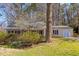 This house features a well-maintained lawn, mature trees, and covered front porch at 901 Emory Ln, Raleigh, NC 27609