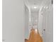 Hallway featuring hardwood flooring, crisp white walls, and well-lit ambiance at 901 Emory Ln, Raleigh, NC 27609