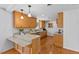 Bright kitchen boasting wood cabinets, granite countertops, stainless appliances, and hardwood floors at 901 Emory Ln, Raleigh, NC 27609