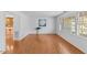 Spacious living room with hardwood floors, large windows, and ample natural light at 901 Emory Ln, Raleigh, NC 27609