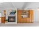 Cozy living room featuring a brick fireplace, built-in cabinetry, and neutral decor at 901 Emory Ln, Raleigh, NC 27609
