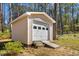 The backyard features a well-maintained storage shed with a roll-up door for easy access and secure storage at 901 Emory Ln, Raleigh, NC 27609