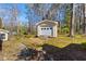 A versatile storage shed with a roll-up door and ramp is nestled in the backyard of the property at 901 Emory Ln, Raleigh, NC 27609