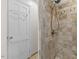 Tiled shower featuring neutral tones, a shower head, and accessibility features at 901 Emory Ln, Raleigh, NC 27609