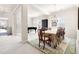 Spacious dining room with elegant chandelier, adjacent to the piano and living areas at 922 Tupelo Glen Ct, Fuquay Varina, NC 27526