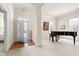 Bright foyer featuring a grand piano, hardwood floors and an abundance of natural light at 922 Tupelo Glen Ct, Fuquay Varina, NC 27526