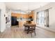 Bright eat-in kitchen features wooden cabinetry, island, and a dining table set by a window at 922 Tupelo Glen Ct, Fuquay Varina, NC 27526