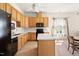 Well-lit kitchen featuring wood cabinets, a center island, and modern appliances at 922 Tupelo Glen Ct, Fuquay Varina, NC 27526