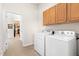 Convenient laundry room with washer, dryer and overhead cabinets at 922 Tupelo Glen Ct, Fuquay Varina, NC 27526