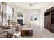 Cozy living room with fireplace, coffee table, chairs, and access to the outside at 922 Tupelo Glen Ct, Fuquay Varina, NC 27526
