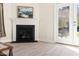 Living room detail featuring a fireplace and access to the back yard at 922 Tupelo Glen Ct, Fuquay Varina, NC 27526