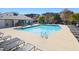 Community pool with lounge chairs and umbrella tables at 922 Tupelo Glen Ct, Fuquay Varina, NC 27526