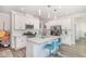 Modern kitchen featuring a quartz island, white cabinets, and stainless steel appliances at 101 Maroon Ct, Raleigh, NC 27610