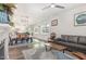 Spacious living room with a dining table, view to the kitchen and a comfortable leather sofa at 101 Maroon Ct, Raleigh, NC 27610