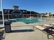Community pool with plenty of chairs and a stylish clubhouse offers residents an upscale leisure experience at 101 Maroon Ct, Raleigh, NC 27610