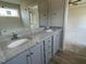 Granite countertop bathroom with double sinks and neutral walls at 102 Heatherglenn Cir, Princeton, NC 27569
