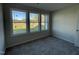 Cozy room with carpet floors and a triple window, providing a bright and comfortable space at 102 Heatherglenn Cir, Princeton, NC 27569