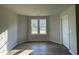 Cozy room featuring wood floors, a double window, and a door, creating a bright and airy space at 102 Heatherglenn Cir, Princeton, NC 27569