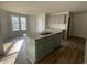 This spacious kitchen island has stainless steel appliances, and wood flooring at 102 Heatherglenn Cir, Princeton, NC 27569