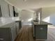 Open kitchen with granite countertops, stainless steel sink and appliances, and gray cabinets at 102 Heatherglenn Cir, Princeton, NC 27569