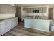 Open kitchen with granite countertops, stainless steel appliances, and gray cabinets at 102 Heatherglenn Cir, Princeton, NC 27569