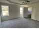 Main bedroom with carpeted floor, tray ceiling and two windows offering natural light at 102 Heatherglenn Cir, Princeton, NC 27569