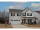 Inviting two-story home with a covered porch, two-car garage, and neat landscaping at 110 Manor Stone Dr, Clayton, NC 27527